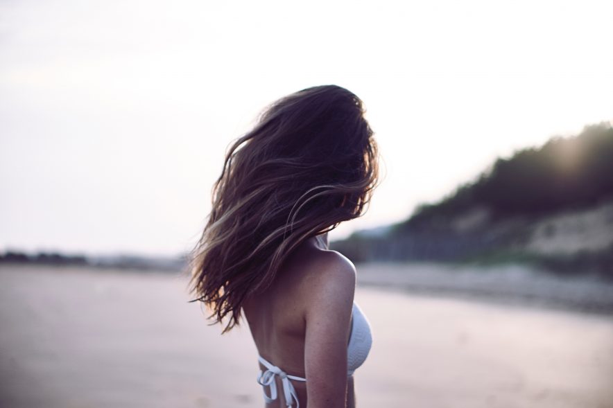 A girl on the beach with a new hair cut