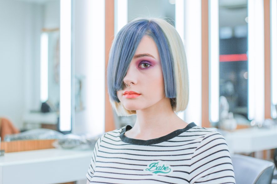 A girl with colourful hair leaving the salon