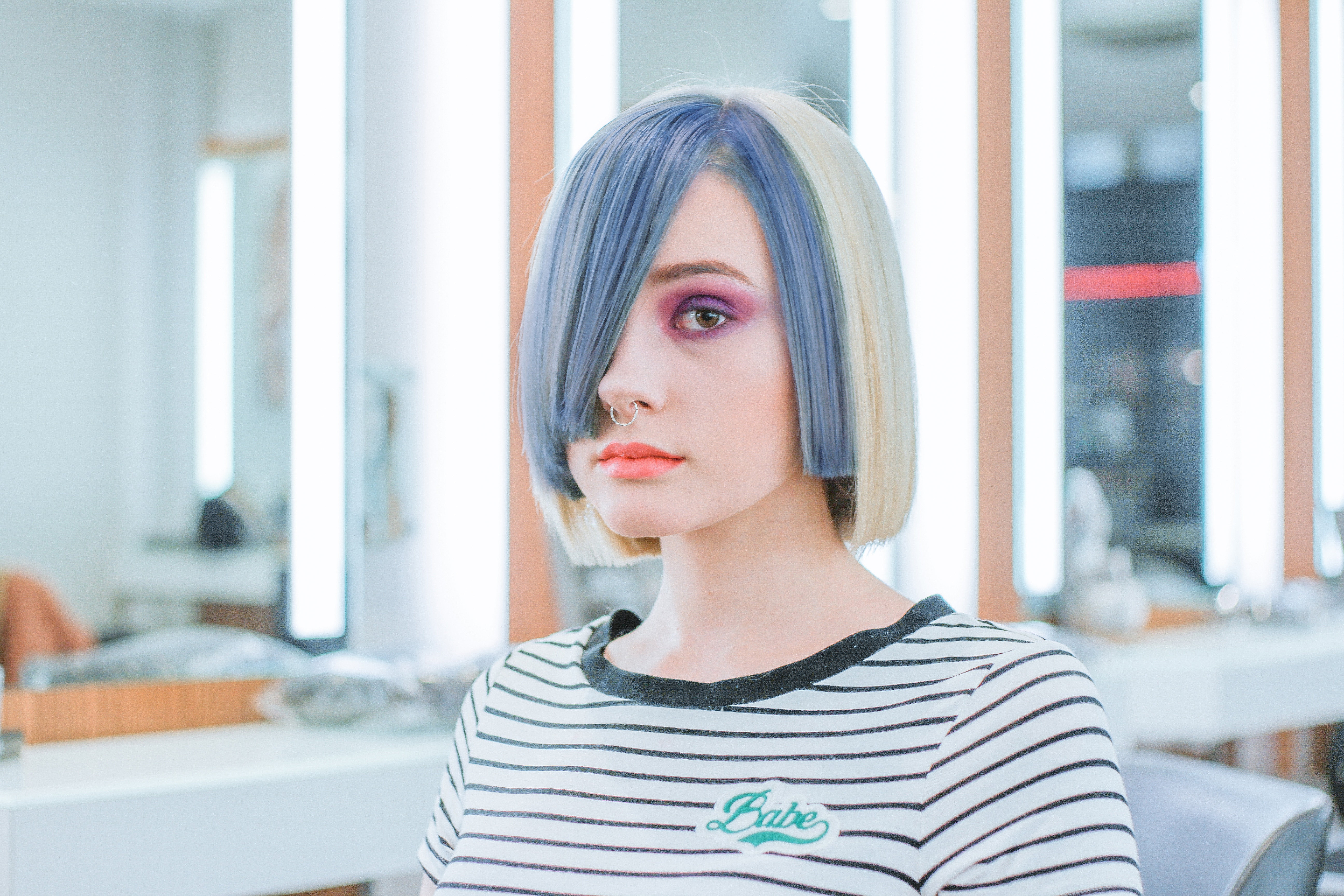 A girl with colourful hair leaving the salon